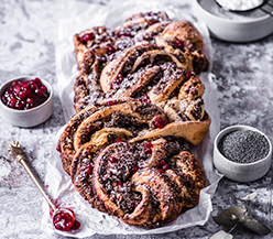Braided almond and poppy seed cake with wild lingonberries